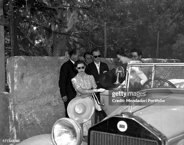 The Princess of England Margaret Countess of Snowdon and Queen of United Kingdom Elizabeth II's sister getting off a car. Capri, 1949