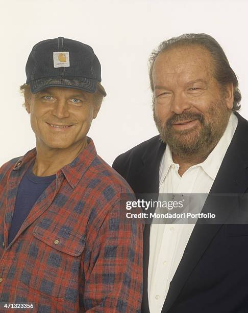 Portrait of Italian actor and director Terence Hill with a Carhartt cap smiling beside Italian actor and swimmer Bud Spencer . 1994