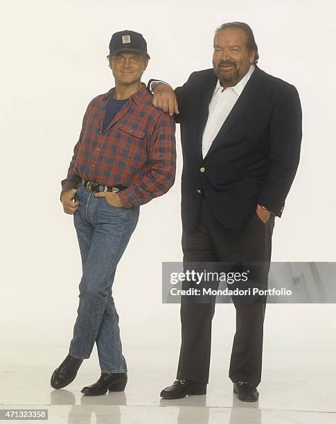 Italian actor and director Terence Hill with a Carhartt cap smiling beside Italian actor and swimmer Bud Spencer . 1994