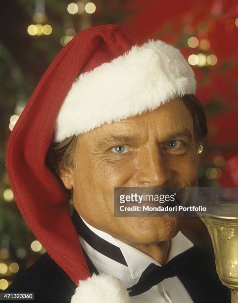 Portrait of Italian actor and director Terence Hill wearing a Santa hat. He's one of the main characters of the film Troublemakers. 1994