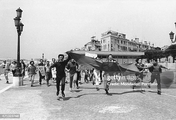 Artists and students parading along the Grand Canal with some banners during the demonstrations at the opening of the 34th Biennale of Venice....