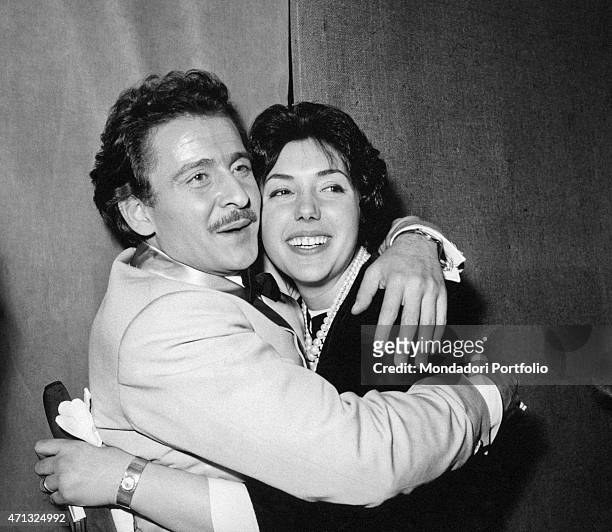 Italian singer-songwriter and actor Domenico Modugno hugging his wife and Italian actress Franca Gandolfi . 1950s