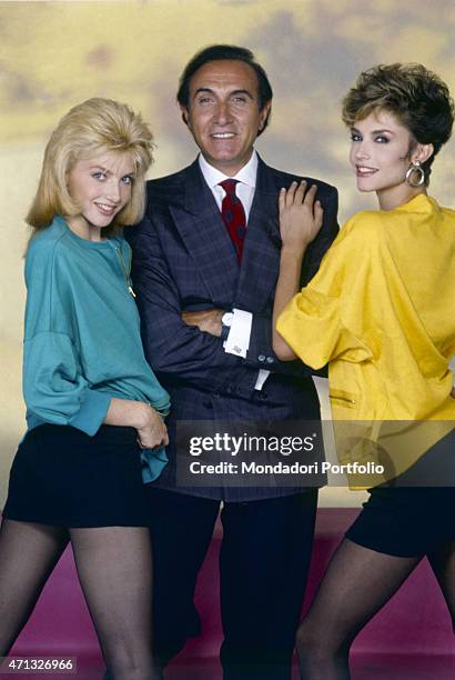 Italian TV host Pippo Baudo posing with Italian showgirls Lorella Cuccarini and Alessandra Martines. The three artists present the TV variety show...