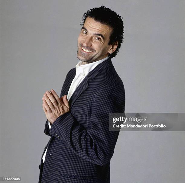 Italian actor and director Massimo Troisi joking during a photo shooting. 1989