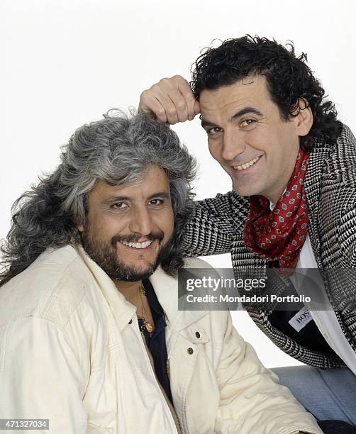 Italian actor and director Massimo Troisi smiling beside Italian singer-songwriter Pino Daniele. 1991