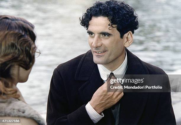 Italian actor and director Massimo Troisi tying his tie in the film Le vie del Signore sono finite. 1987