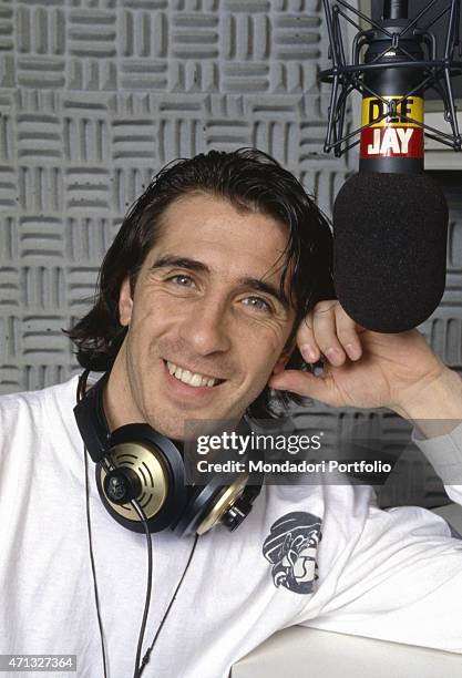 Italian disc jockey and music producer Mario Fargetta posing smiling in the Radio Deejay studio. Milan, 1995