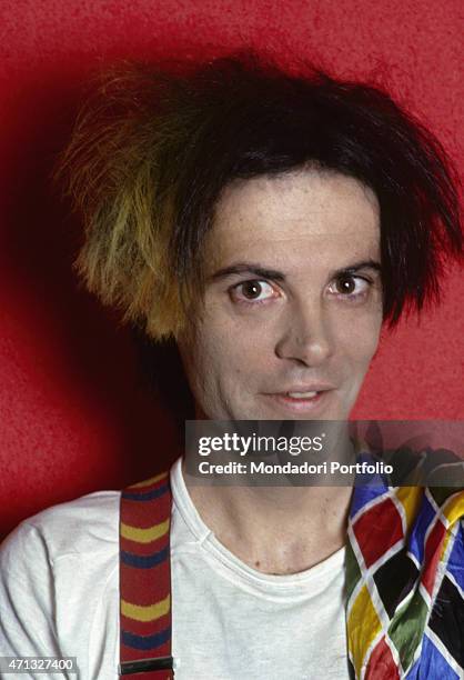 Portrait of Italian singer-songwriter, guitarist and theatre artist Alberto Camerini dressed as Arlecchino. Italy, 1981