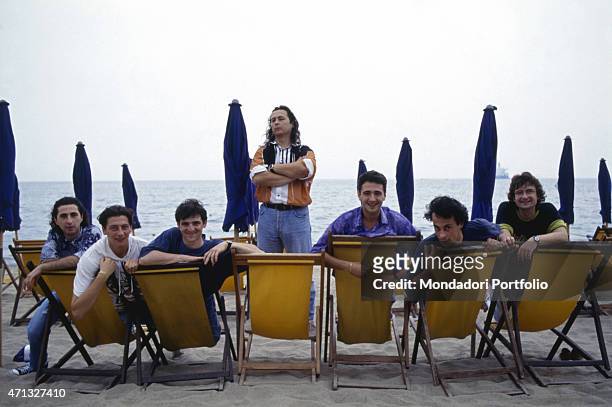 Italian band Ladri di biciclette posing sitting on some deck-chairs while the leader of the band and Italian singer Paolo Belli is looking into the...