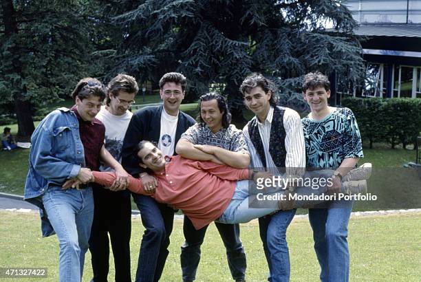 Italian band Ladri di biciclette posing with Italian singer-songwriter Francesco Baccini with whom they wrote and recorded the song Sotto questo...
