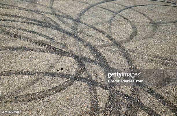 Detail of tyre marks as people gather on an abandoned road to participate in street racing on the outskirts of Odessa on April 26, 2015 in Odessa,...