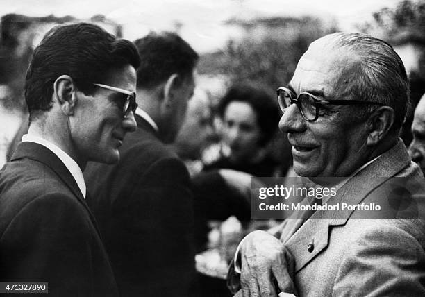 Italian publisher Arnoldo Mondadori chatting with Italian writer and director Pier Paolo Pasolini at the Strega Prize. Rome, 1962