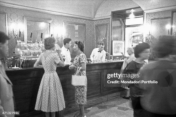 Two barmen working behind the counter of the Antico CaffGreco on via Condotti. Rome, August 1958