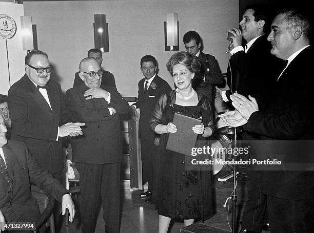 Italian director Mario Landi and Italian actress Andreina Pagnani getting the award Cassaforte d'Oro, from the company Parma Antonio e Figli di...