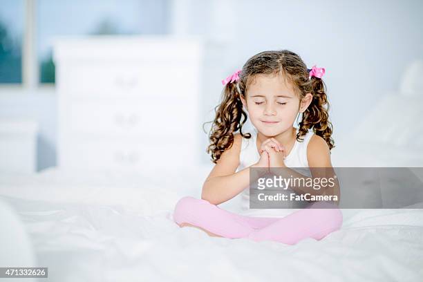 little girl with folded hands - child praying stock pictures, royalty-free photos & images