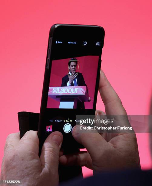 Member of the audience photographs Labour Party leader Ed Miliband as he addresses supporters during a campaign visit to Stockton Arts Centre on...