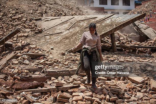 Volunteer walks on top of the debris of a collapsed temple at Basantapur Durbar Square on April 27, 2015 in Kathmandu, Nepal. A major 7.8 earthquake...