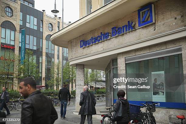 People walk past a branch of German bank Deutsche Bank on April 27, 2015 in Berlin, Germany. Deutsche Bank announced earlier in the day that it will...