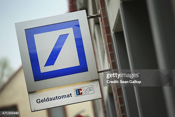 The logo of German bank Deutsche Bank hangs over one of the bank's branches on April 27, 2015 in Berlin, Germany. Deutsche Bank announced earlier in...