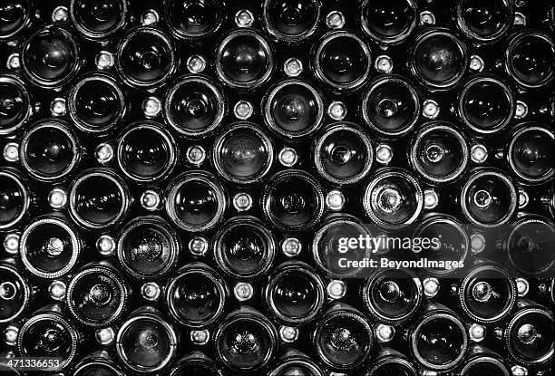 end view of vintage sparkling wine bottle stack - large group of objects stock pictures, royalty-free photos & images