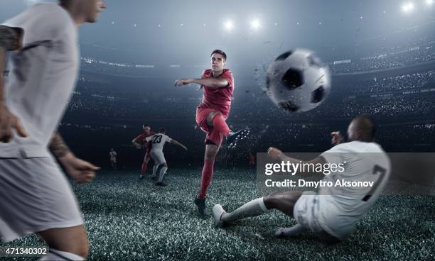 soccer player kicking ball in stadium - shooting football stock pictures, royalty-free photos & images