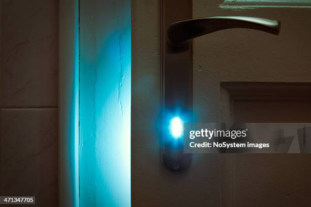 mysterious blue light and keyhole - key hole stock pictures, royalty-free photos & images