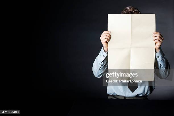 business man holding up blank newspaper - man holding paper stock pictures, royalty-free photos & images