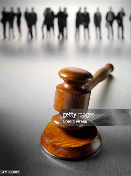 business people standing around a gavel - legal problems stock pictures, royalty-free photos & images