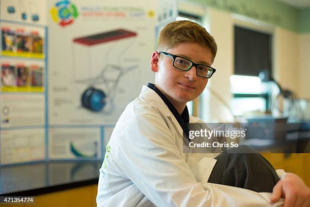 St. Brother Andre Catholic High School Grade 10 student Aidan Aird holds up a 3D auto CAD rendering of a "Multi-Funtional Water Wheel Cart +" , a...