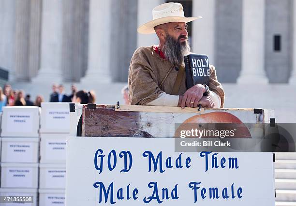 Alan Hoyle, of North Carolina, stands in front of the U.S. Supreme Court with a bible and several large signs opposing gay marriage on Monday, April...