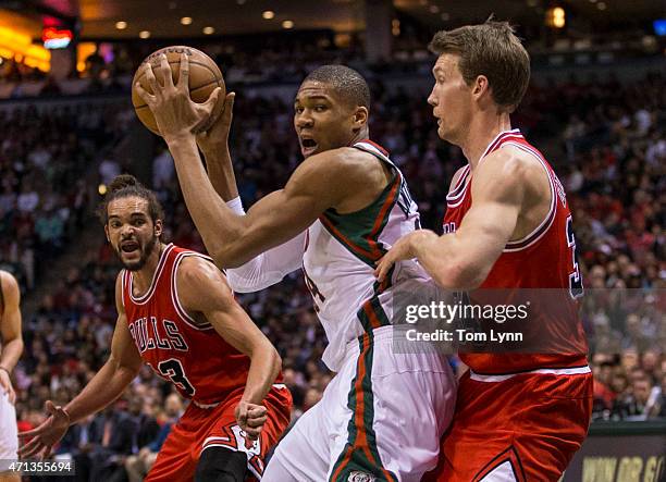 Forward Giannis Antetokounmpo of the Milwaukee Bucks tries to make a move on Mike Dunleavy of the Chicago Bulls in the first quarter of game four of...