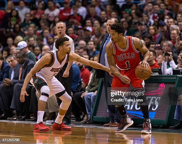 Guard Derrick Rose of the Chicago Bulls looks to make a move on guard Michael Carter-Williams of the Milwaukee Bucks in the first quarter of game...