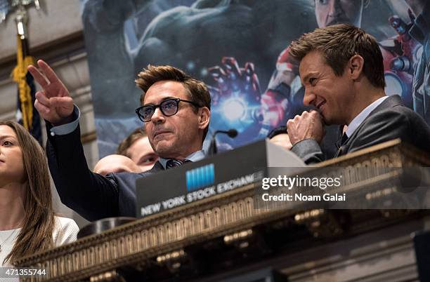 Robert Downey Jr. And Jeremy Renner ring the NYSE opening bell at New York Stock Exchange on April 27, 2015 in New York City.