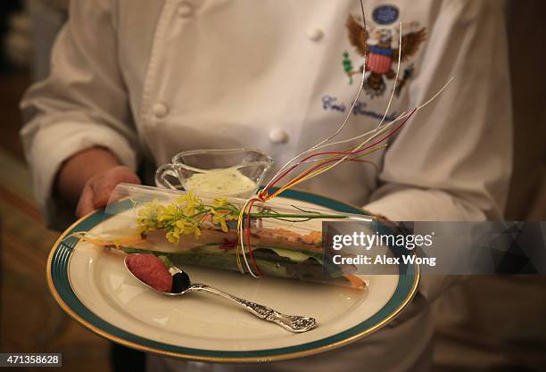 White House Executive Chef Cristeta Comerford introduces the first course from the menu, Toro Tartare and Caesar Sashimi Salad, during a press...