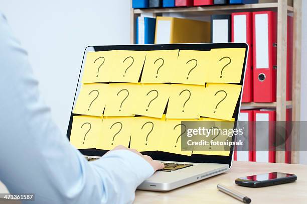 person on their laptop covered in question marks - sticky-notes-covering-computer-monitor stock pictures, royalty-free photos & images