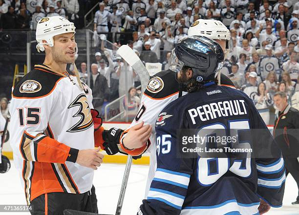 Mathieu Perreault of the Winnipeg Jets congratulates Corey Perry and Ryan Getzlaf of the Anaheim Ducks following a 4-0 series sweep by the Ducks in...