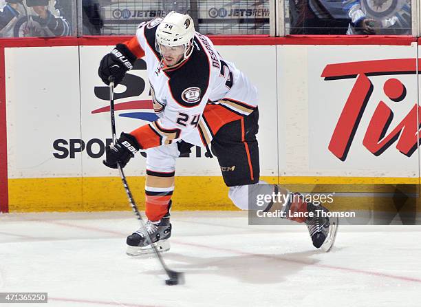 Simon Depres of the Anaheim Ducks shoots the puck down the ice during second period action against the Winnipeg Jets in Game Four of the Western...