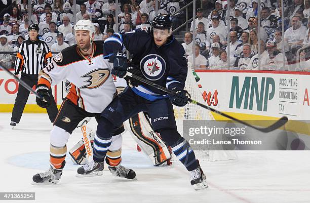 Clayton Stoner of the Anaheim Ducks battles Adam Lowry of the Winnipeg Jets in front of the net during first period action in Game Four of the...