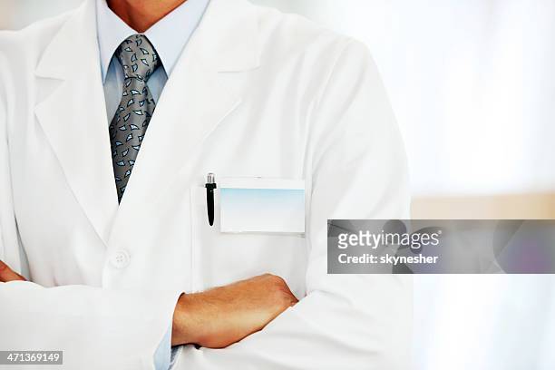 doctor with a blank name tag. - torso stock pictures, royalty-free photos & images