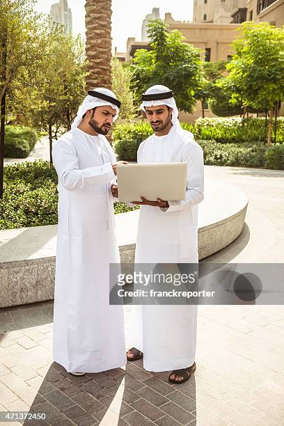 arabic sheik with the technology - emirati laptop stock pictures, royalty-free photos & images