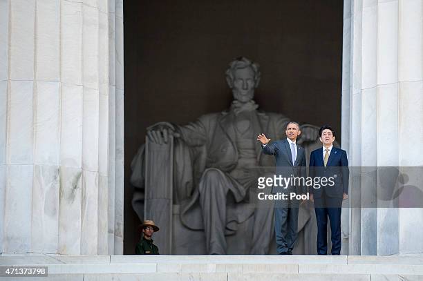 President Barack Obama and Prime Minister Shinzo Abe of Japan turn to look across the reflecting pool as they visit the Lincoln Memorial on April 27,...