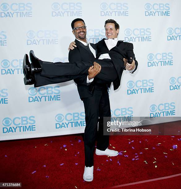 Kristoff St. John lifts Christian LeBlanc at the CBS Daytime Emmy after party at Hollywood Athletic Club on April 26, 2015 in Hollywood, California.