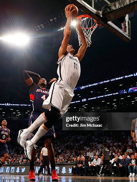 Brook Lopez of the Brooklyn Nets goes to the hoop in the first quarter against Paul Millsap of the Atlanta Hawks during game four in the first round...