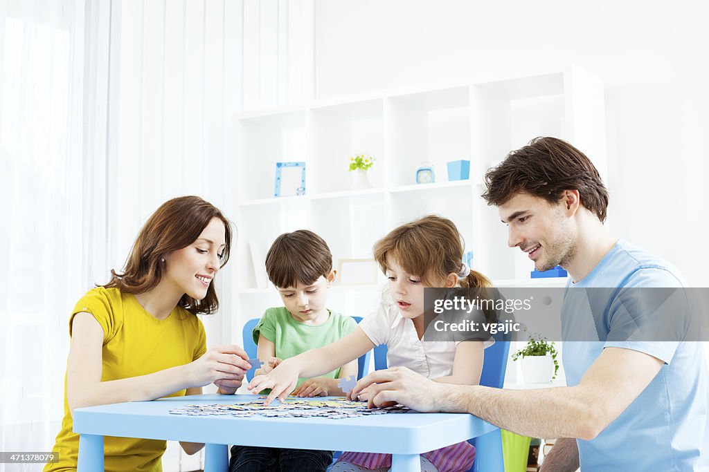 Family Playing Puzzle Game at home.