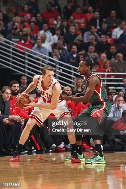 Mike Dunleavy of the Chicago Bulls handles the ball against Khris Middleton of the Milwaukee Bucks in Game Five of the Eastern Conference...