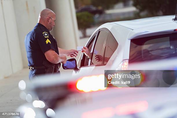 policeman asking a driver for identification - police car lights stock pictures, royalty-free photos & images