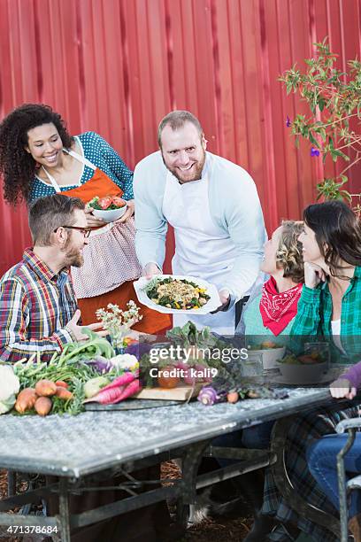 chef serving locally grown food to group of people - farm to table stock pictures, royalty-free photos & images