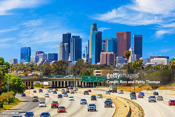 skyline of los angeles with freeway traffic,ca - rush hour highway stock pictures, royalty-free photos & images