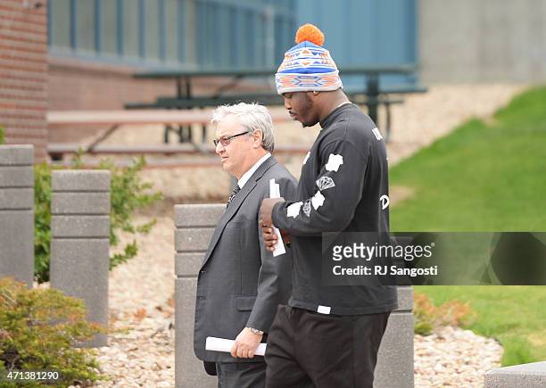 Malik Jackson, right, defensive end for the Denver Broncos, walks out of Arapahoe County Justice Center in Centennial, April 27, 2015. Jackson was...