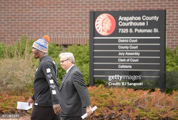 Malik Jackson, left, defensive end for the Denver Broncos, walks out of Arapahoe County Justice Center in Centennial, April 27, 2015. Jackson was...